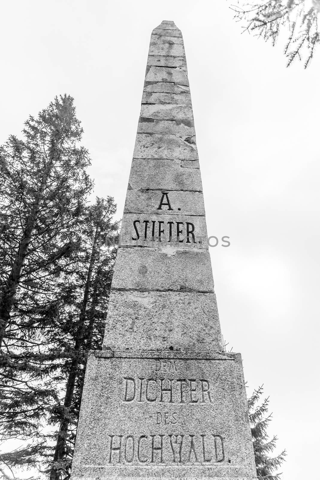 Stone monument of Adalbert Stifter - writer of Sumava Mounains - above Plechy Lake, Sumava National Park, Czech Republic. Black and white image.