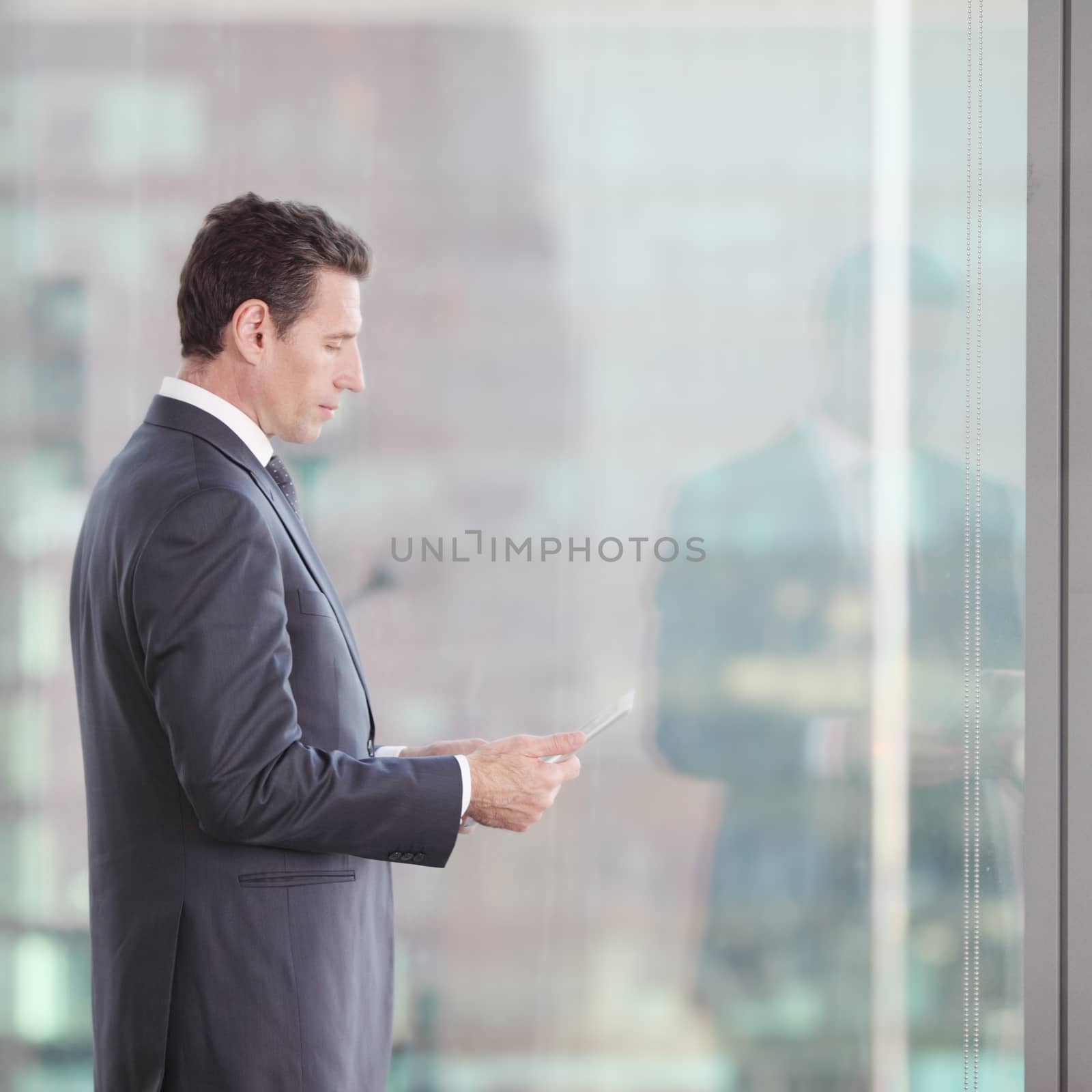 Businessman working with tablet and touching digital display