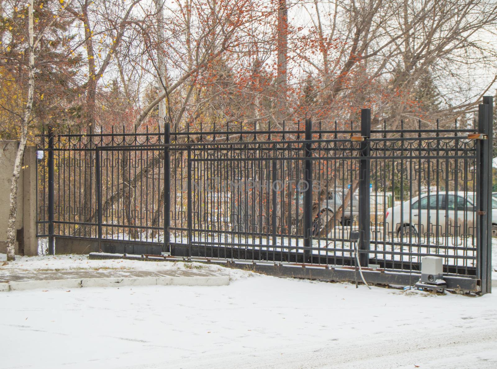 Automatic gate from a metal lattice for protection and safety of the private territory.