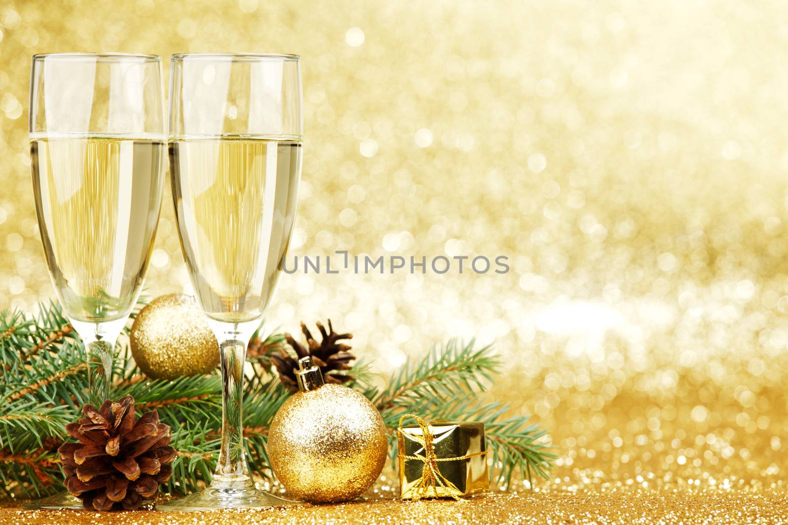 Champagne and new year decorations on golden background
