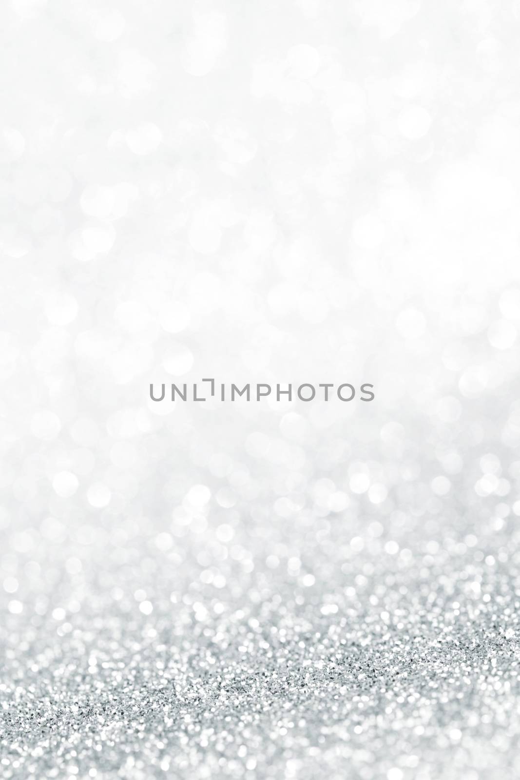 Silver festive glitter background with defocused lights