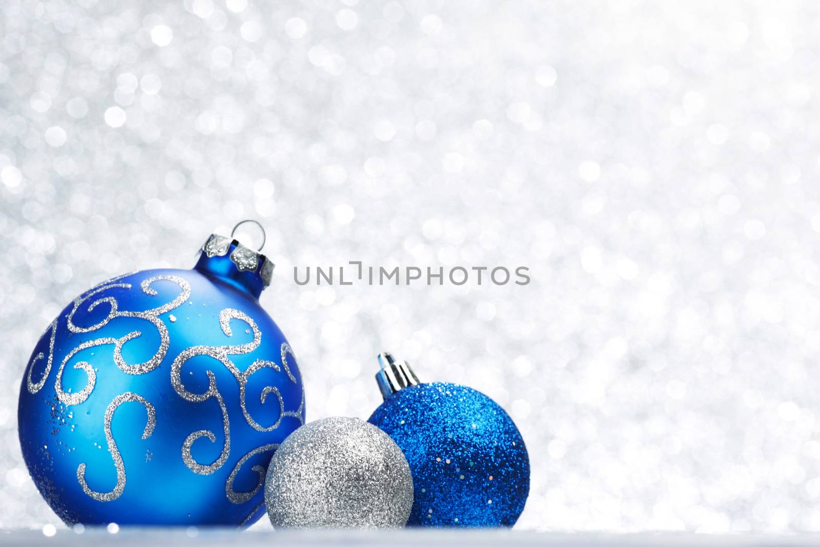 Decorative Christmas balls on abstract glitter silver background
