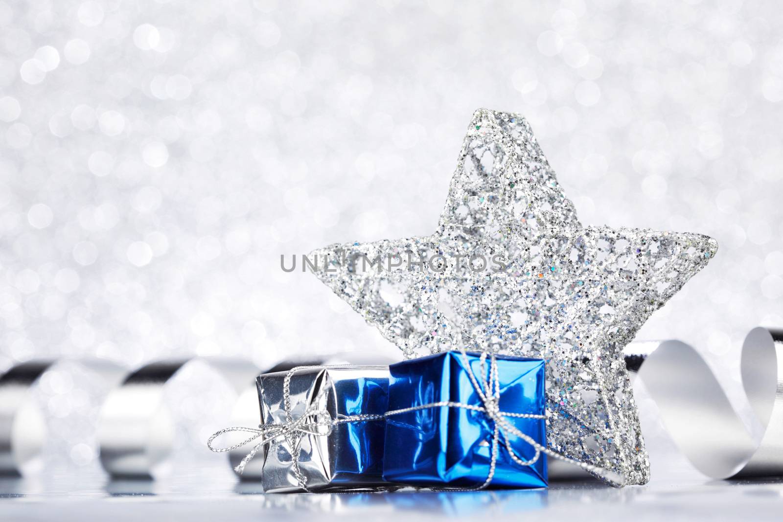 Christmas blue decoration on shiny silver glitter background