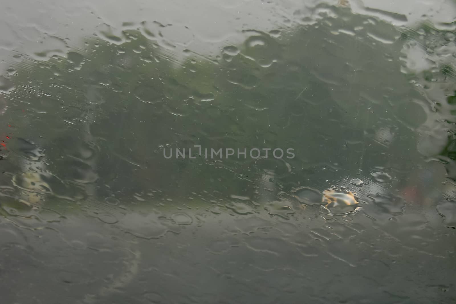 Rain drops on glass with a background.