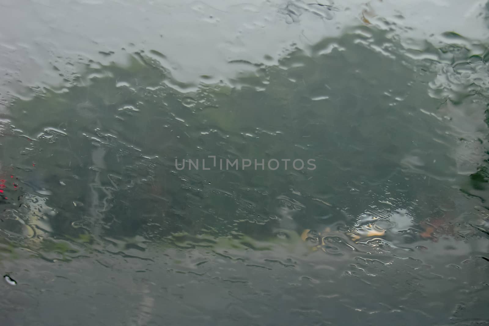 Rain drops on glass with a background.