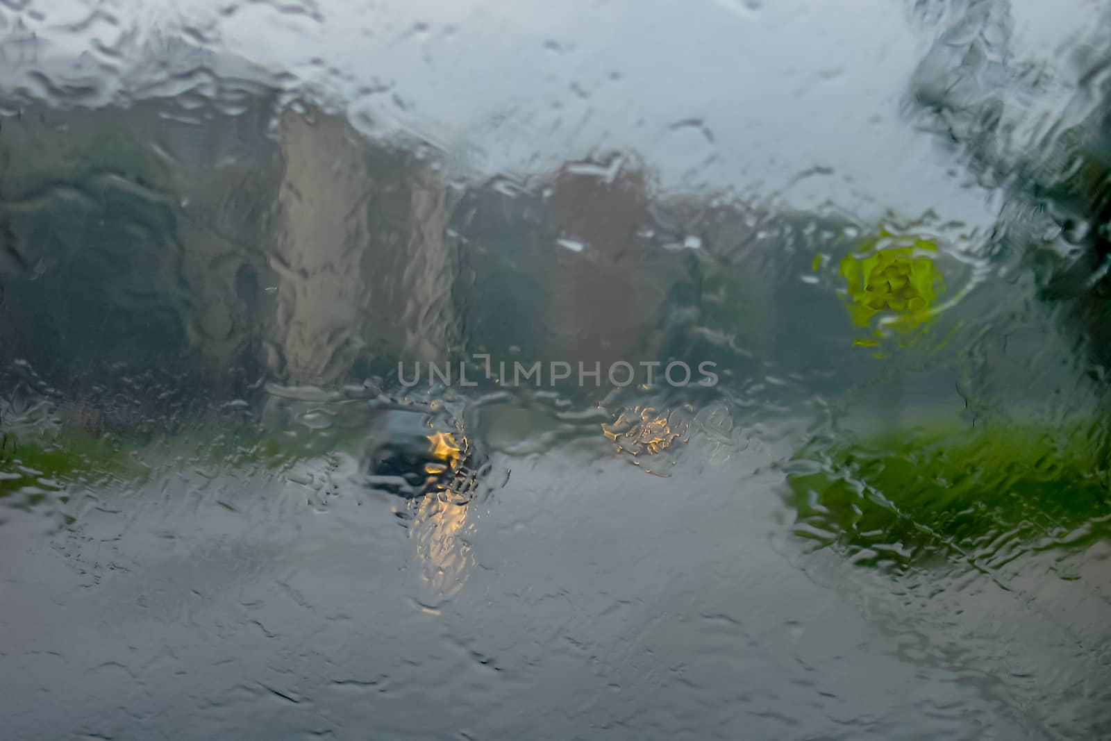 Rain drops on glass with a background.