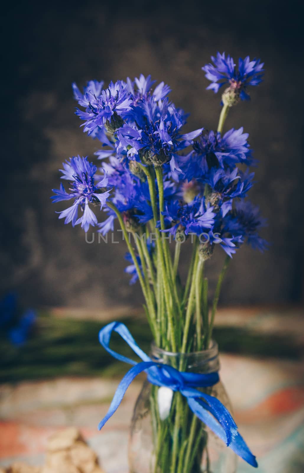 Seasonal summer flowers blue cornflowers and fruits strawberries on a napkin close-up conceptual background by yulaphotographer