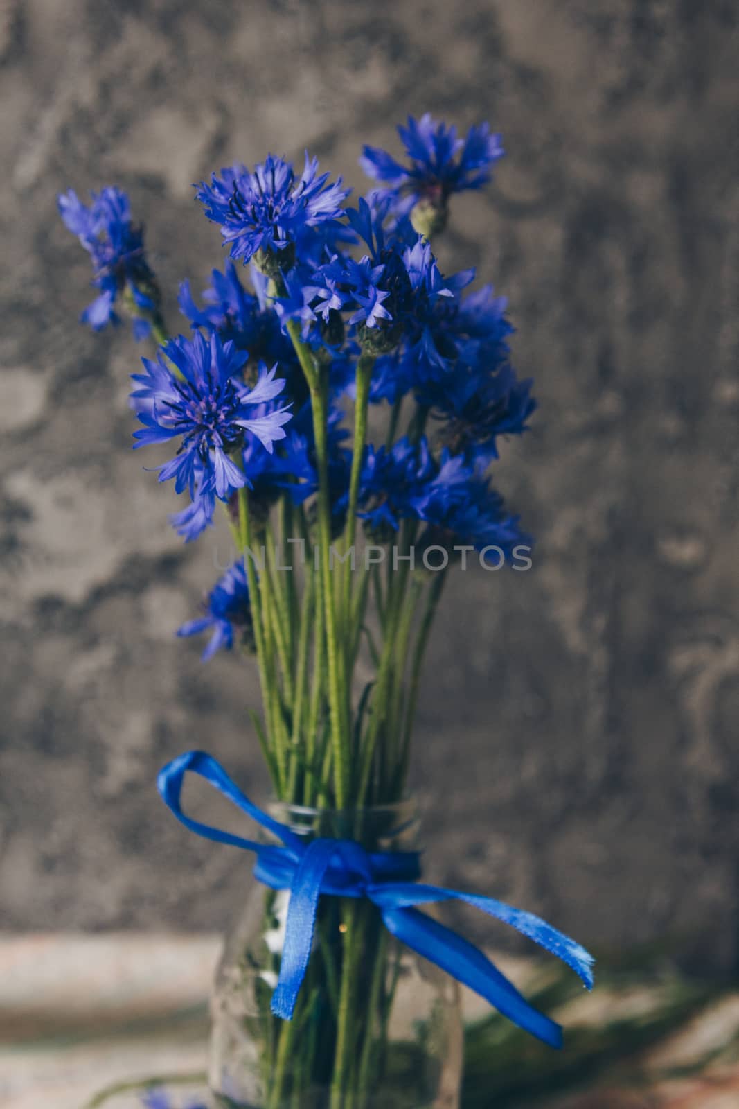 Seasonal summer flowers blue cornflowers and fruits strawberries on a napkin close-up conceptual background by yulaphotographer