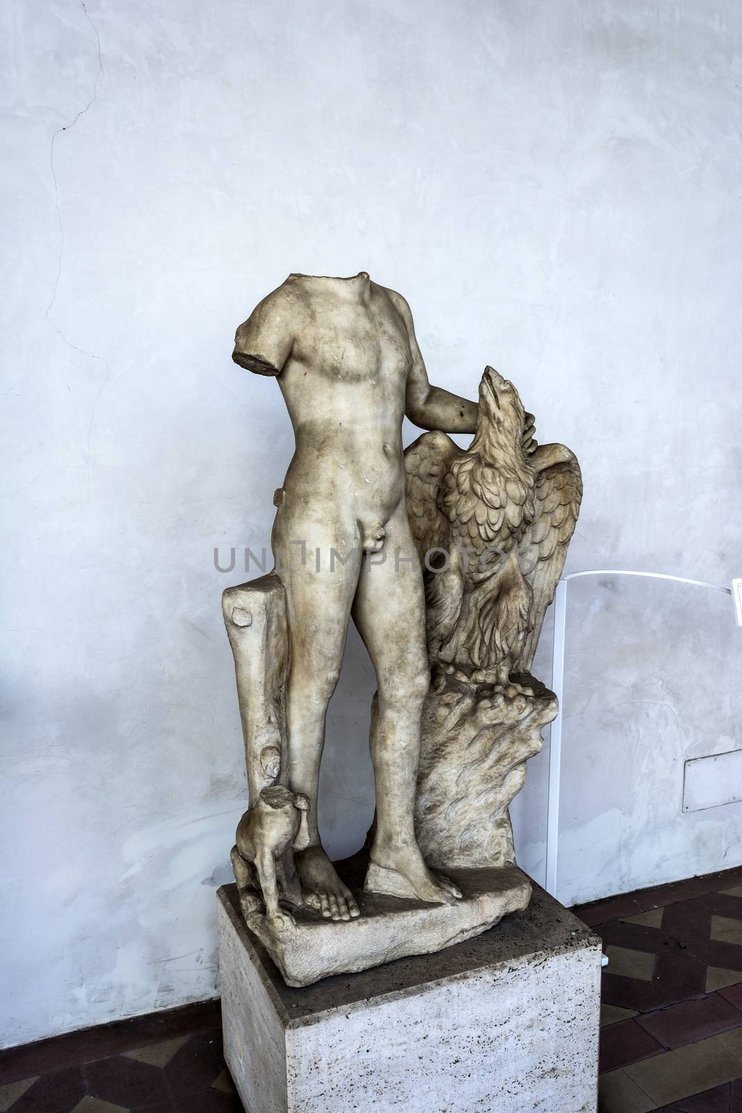 Rome, Italy - September 1, 2017: Ancient sculpture of a man with an eagle in the baths of Diocletian in Rome. Italy