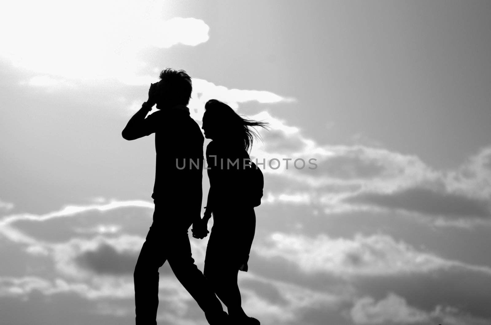 Silhouette of a Couple is walking on the street of Yokohama, Japan. Yokohama is a city located in a little bit of South from Tokyo.
