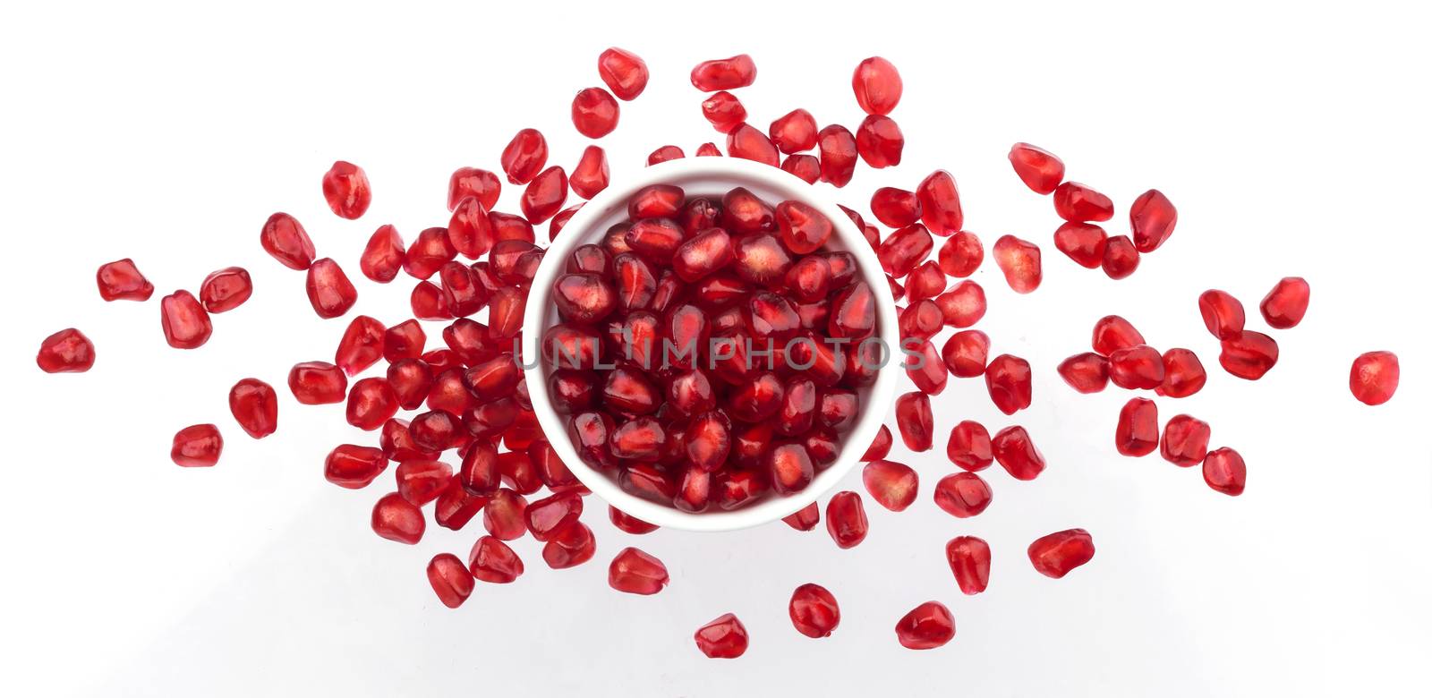 Pomegranate seeds isolated on white background, top view by xamtiw