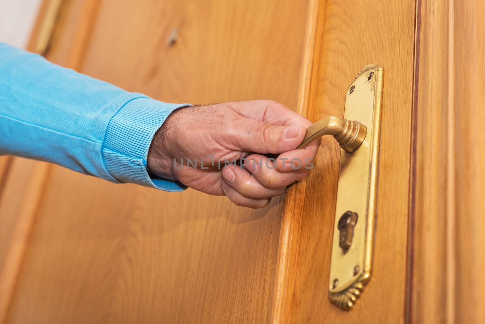 Man hand open door knob by HERRAEZ