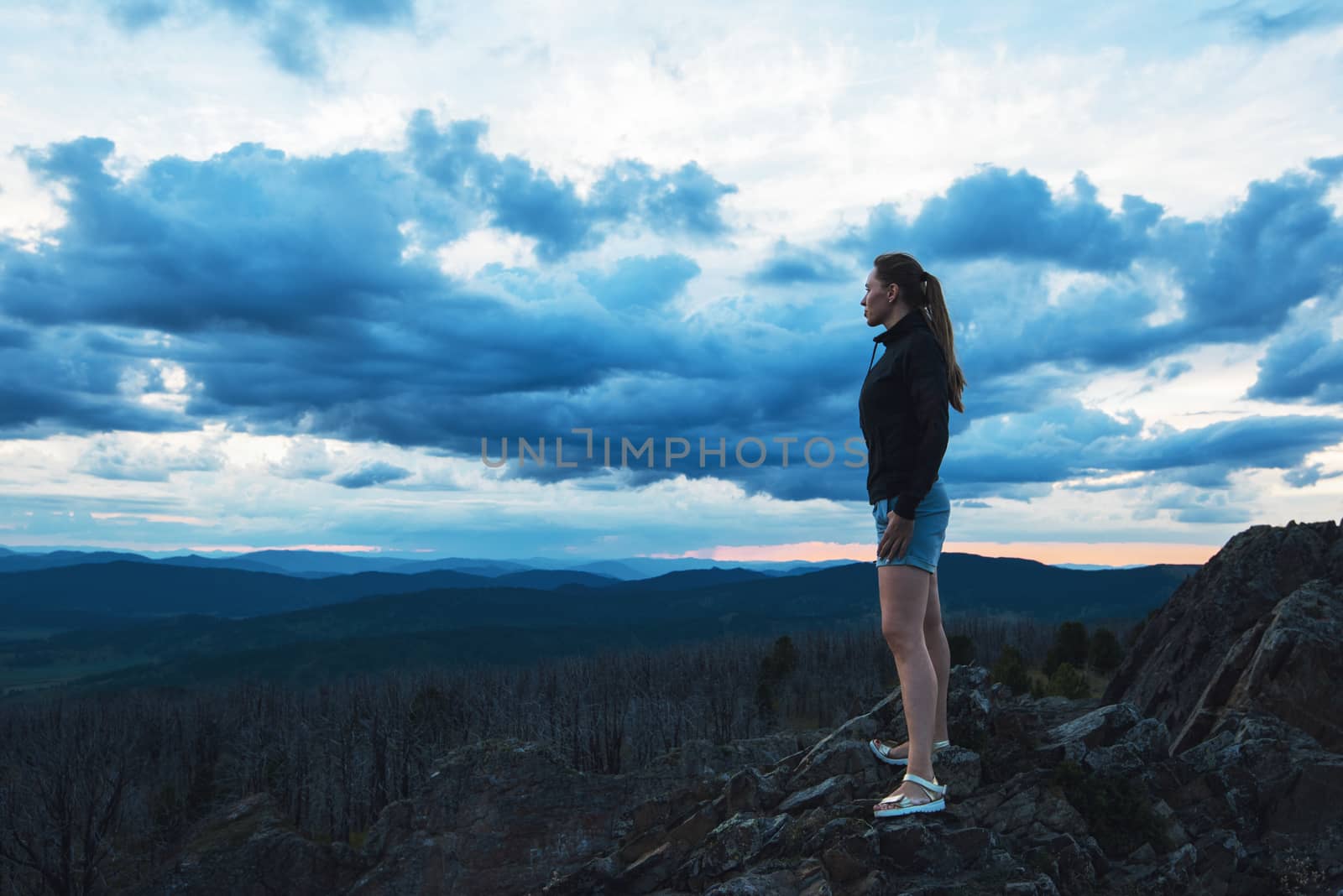 Travel, lesure and freedom concept - woman on the top of Altai mountain, beauty summer evening landcape