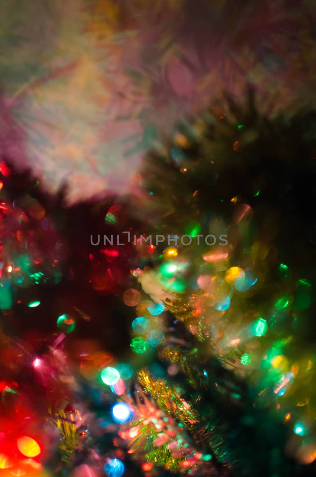 Part of the Christmas tree and lights form an abstract colorful image