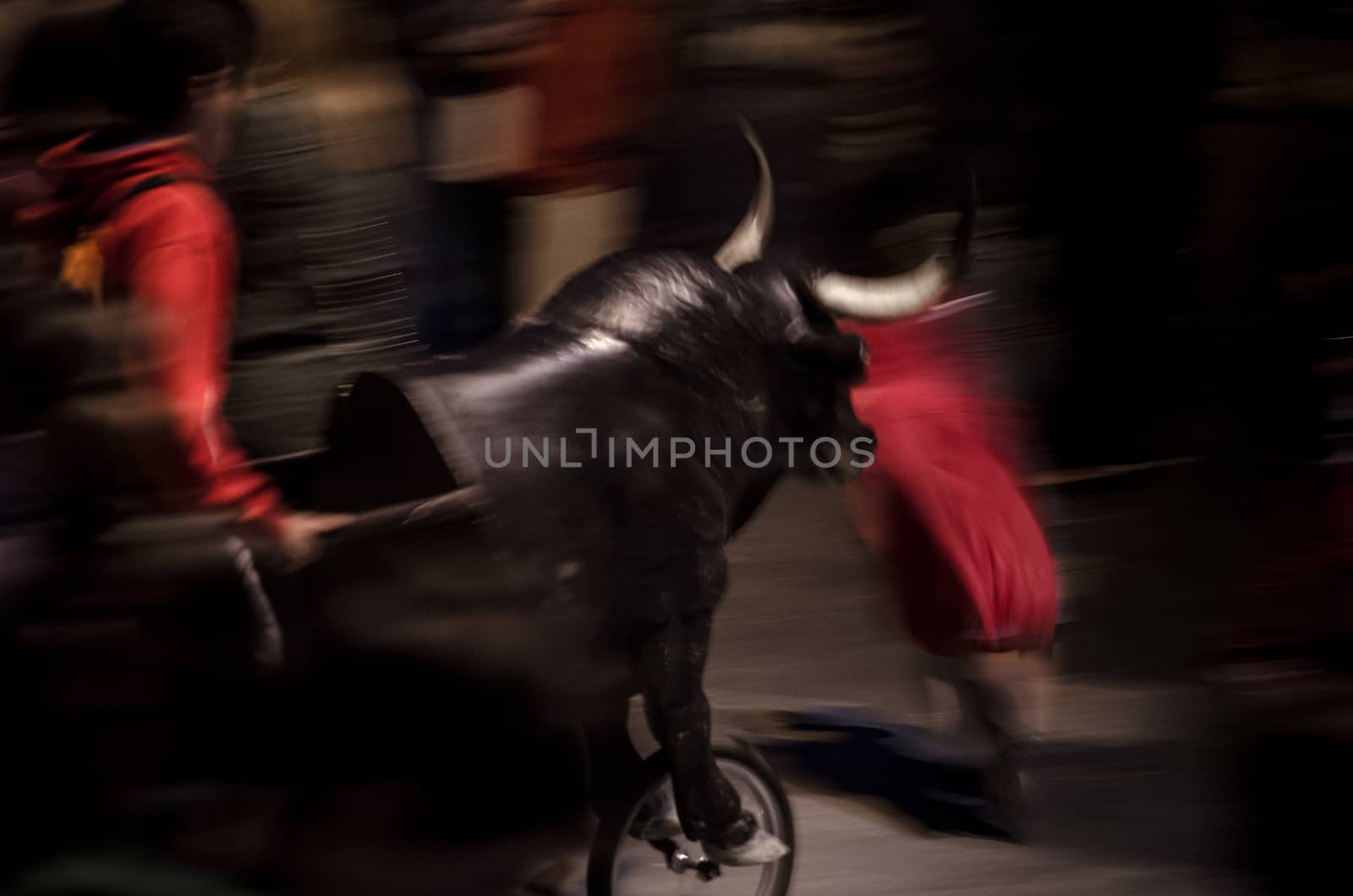 Typical fake bull with a wheel that pursues kids in spanish village festivals