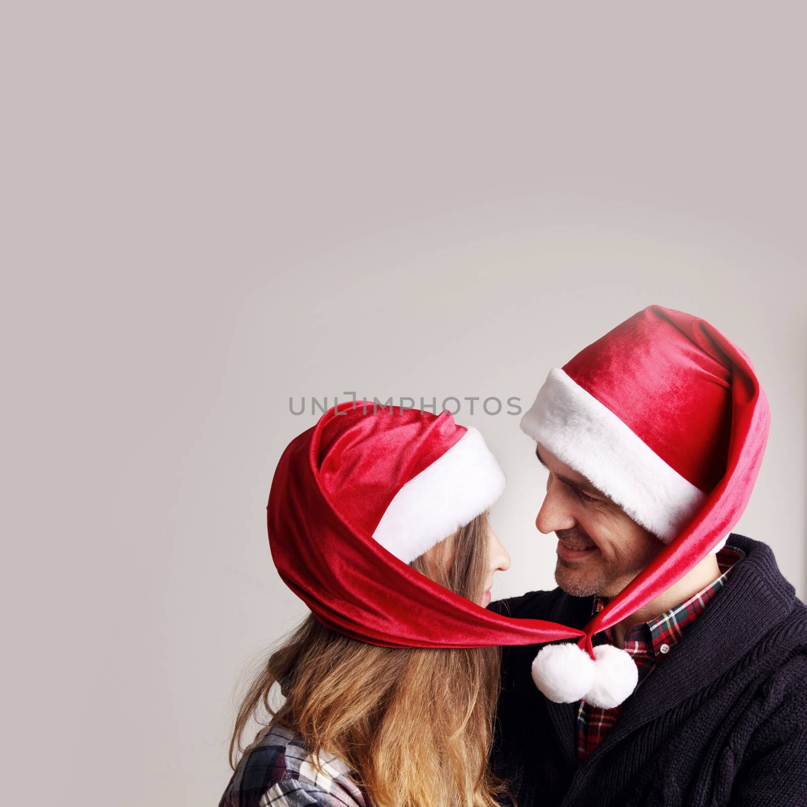 Happy couple in Santa hats by ALotOfPeople