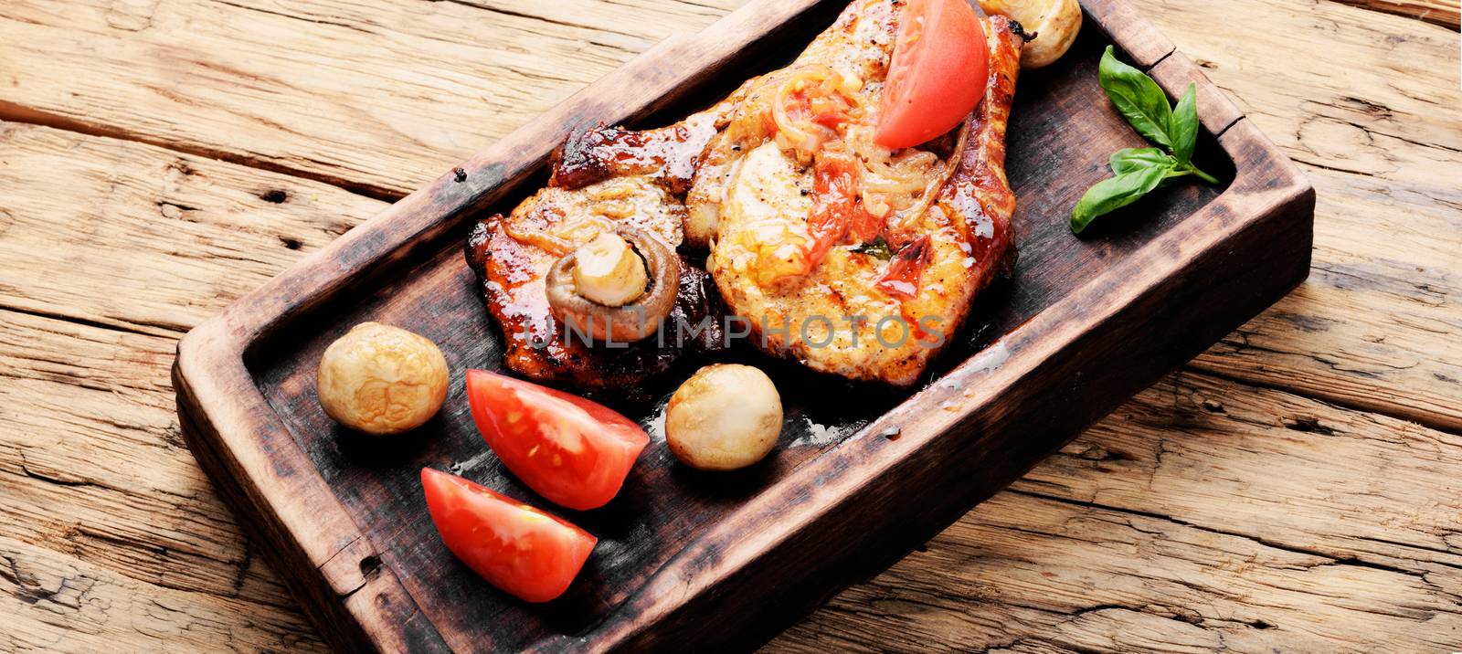 Grilled meat steak,tomato, herbs and spices on cutting board