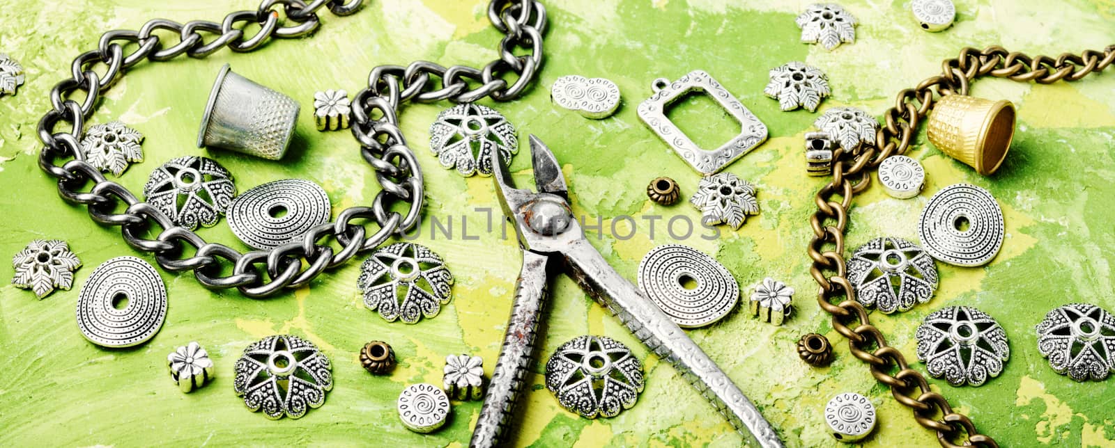 Stylish female retro jewelry made of chains, beads and pendants.Bijouterie making