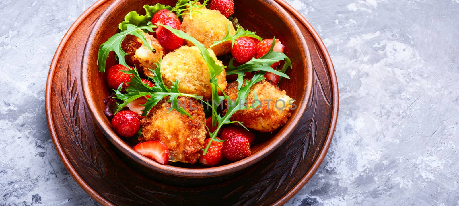 Salad with strawberries, fried cheese and rucola.Healthy eating,