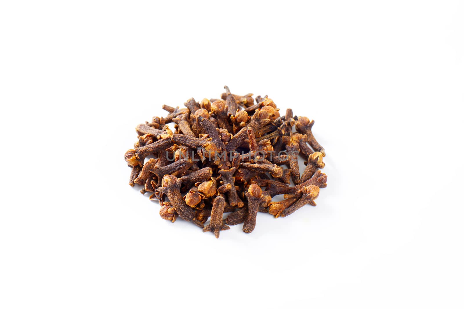 Heap of dried cloves on white background