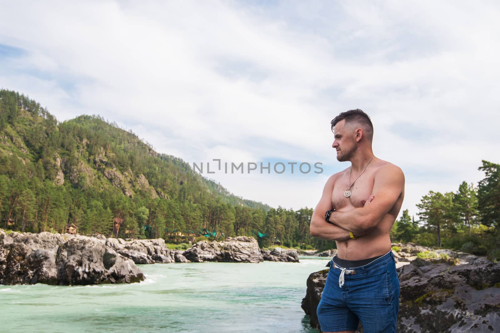 Man resting at river in Altai Mountains territory