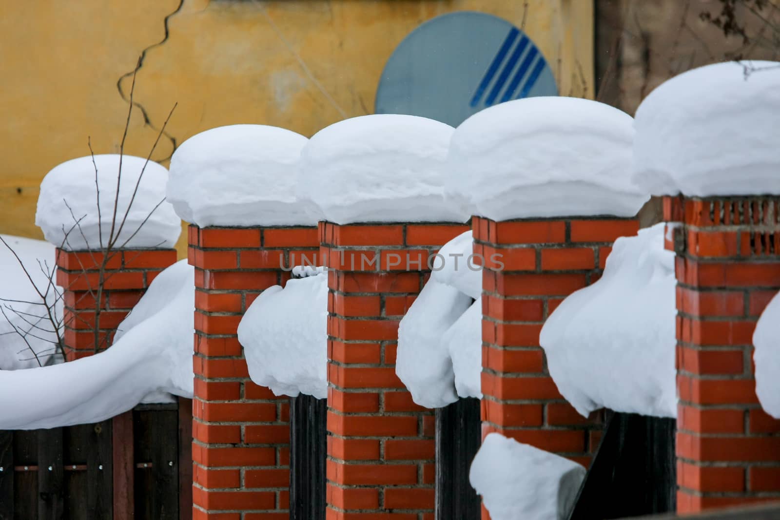 Brick wall, covered with snow in January in Cesis, Latvia.
