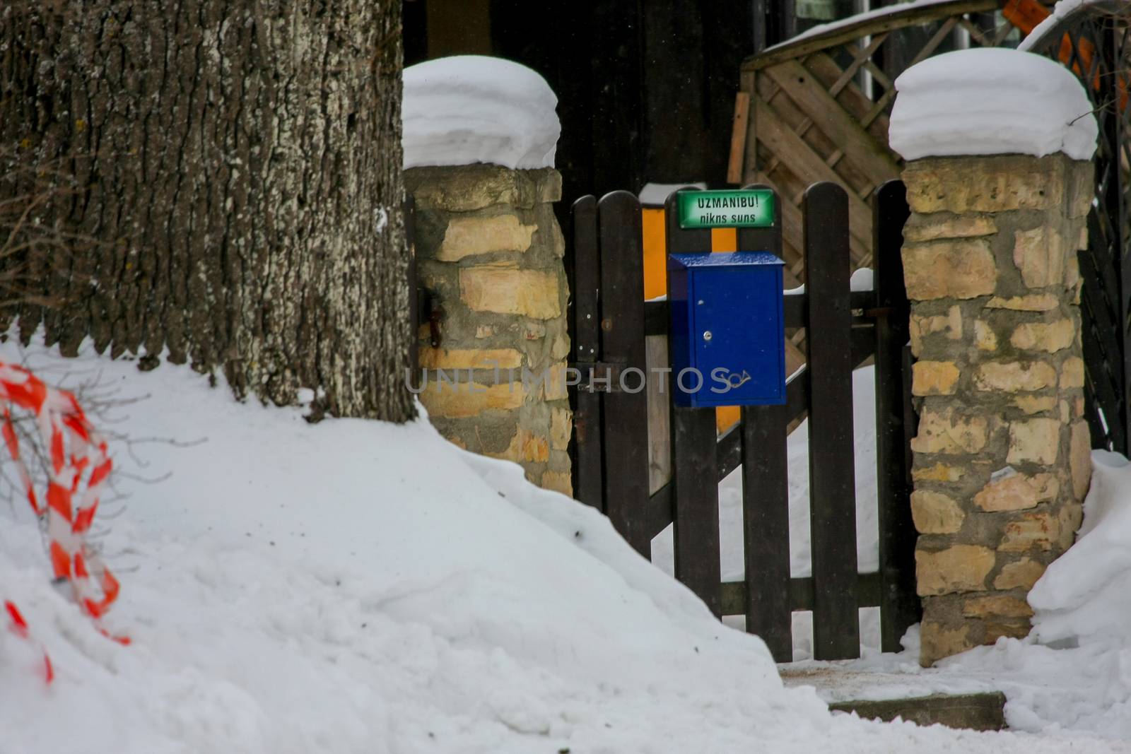 Winter in town. Gateway in Cesis, Latvia. Title on gateway " Attention, raging dog".