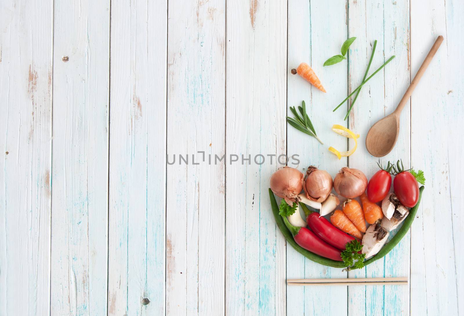 Ingredients in the shape of a soup bowl on a wooden table with space