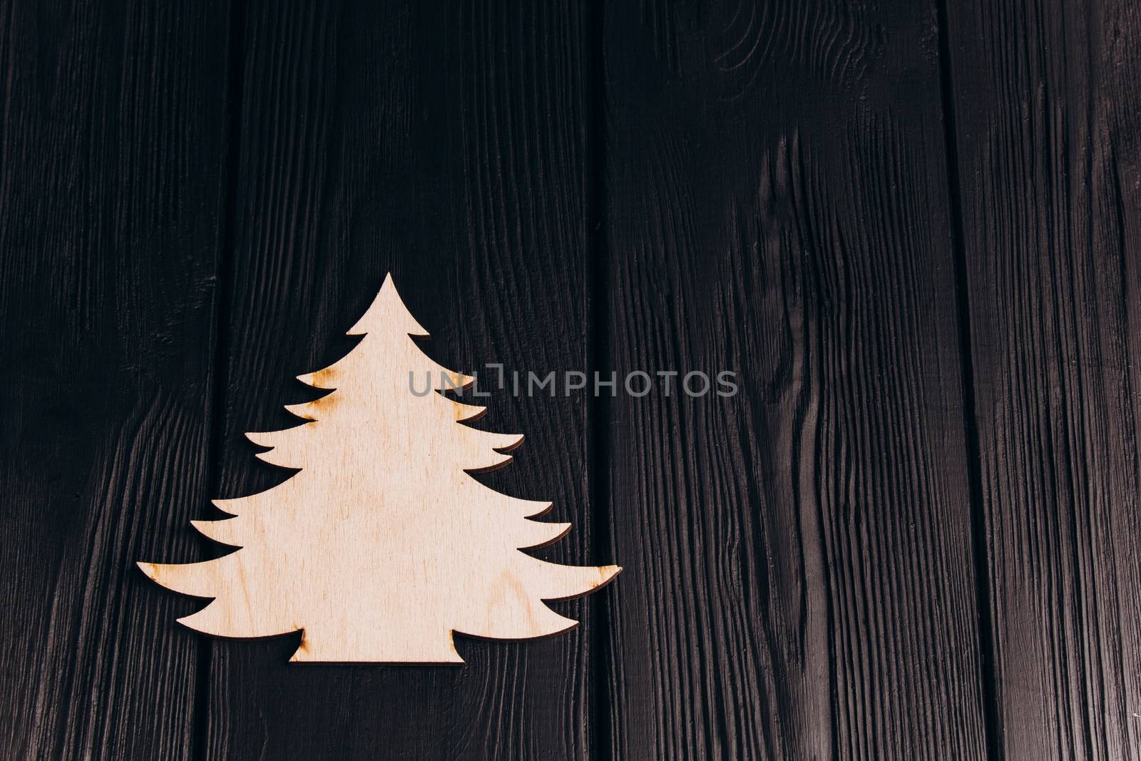 New Year composition with pine tree from plywood. Christmas background for presentation on wooden background by yulaphotographer