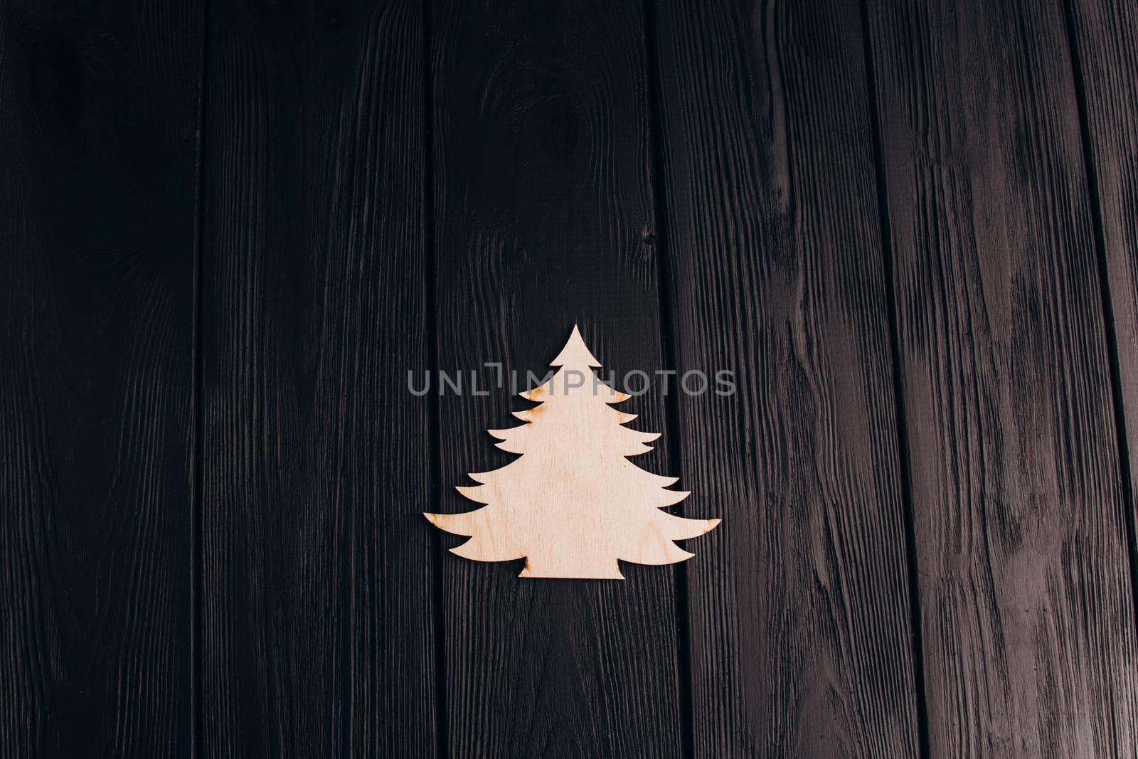 New Year composition with pine tree from plywood. Christmas background for presentation on wooden background by yulaphotographer