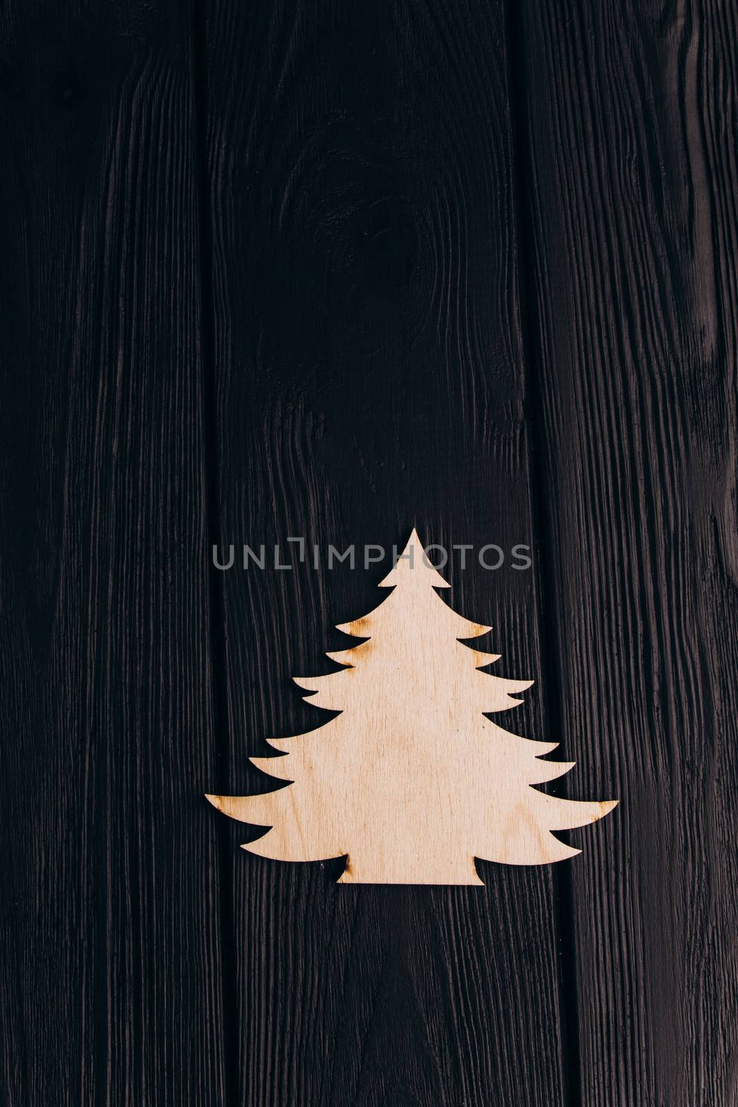 New Year composition with pine tree from plywood. Christmas background for presentation on wooden background by yulaphotographer