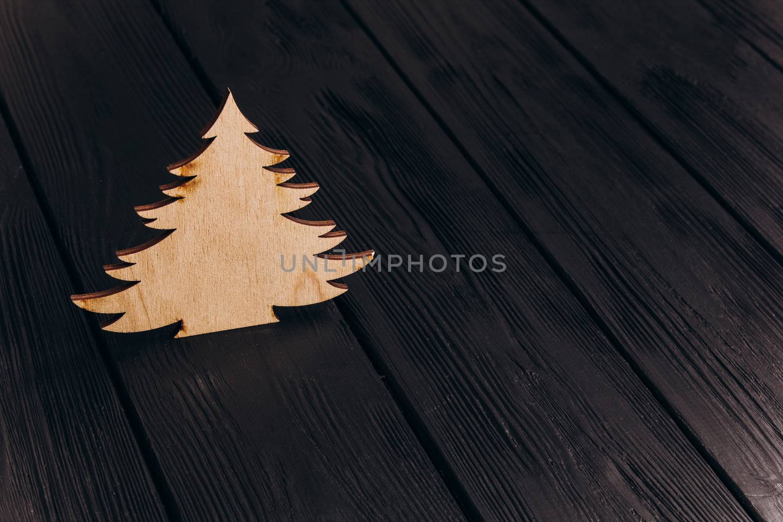 New Year composition with pine tree from plywood. Christmas background for presentation on wooden background by yulaphotographer