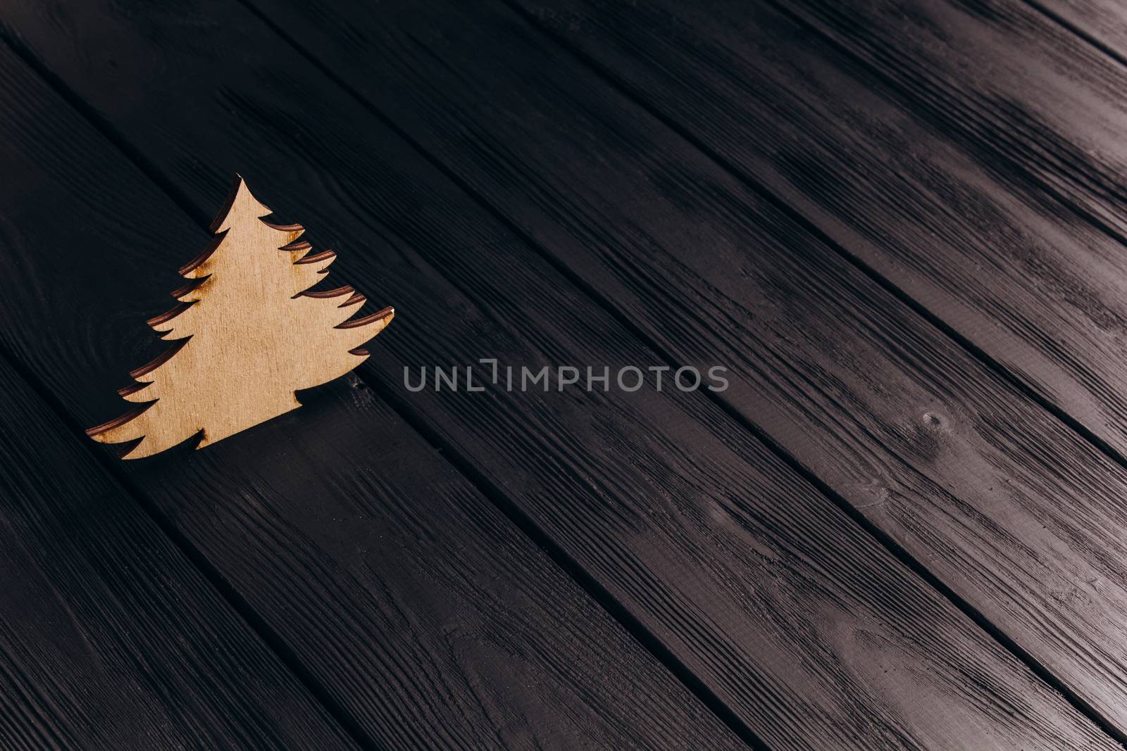 New Year composition with pine tree from plywood. Christmas background for presentation on wooden background by yulaphotographer