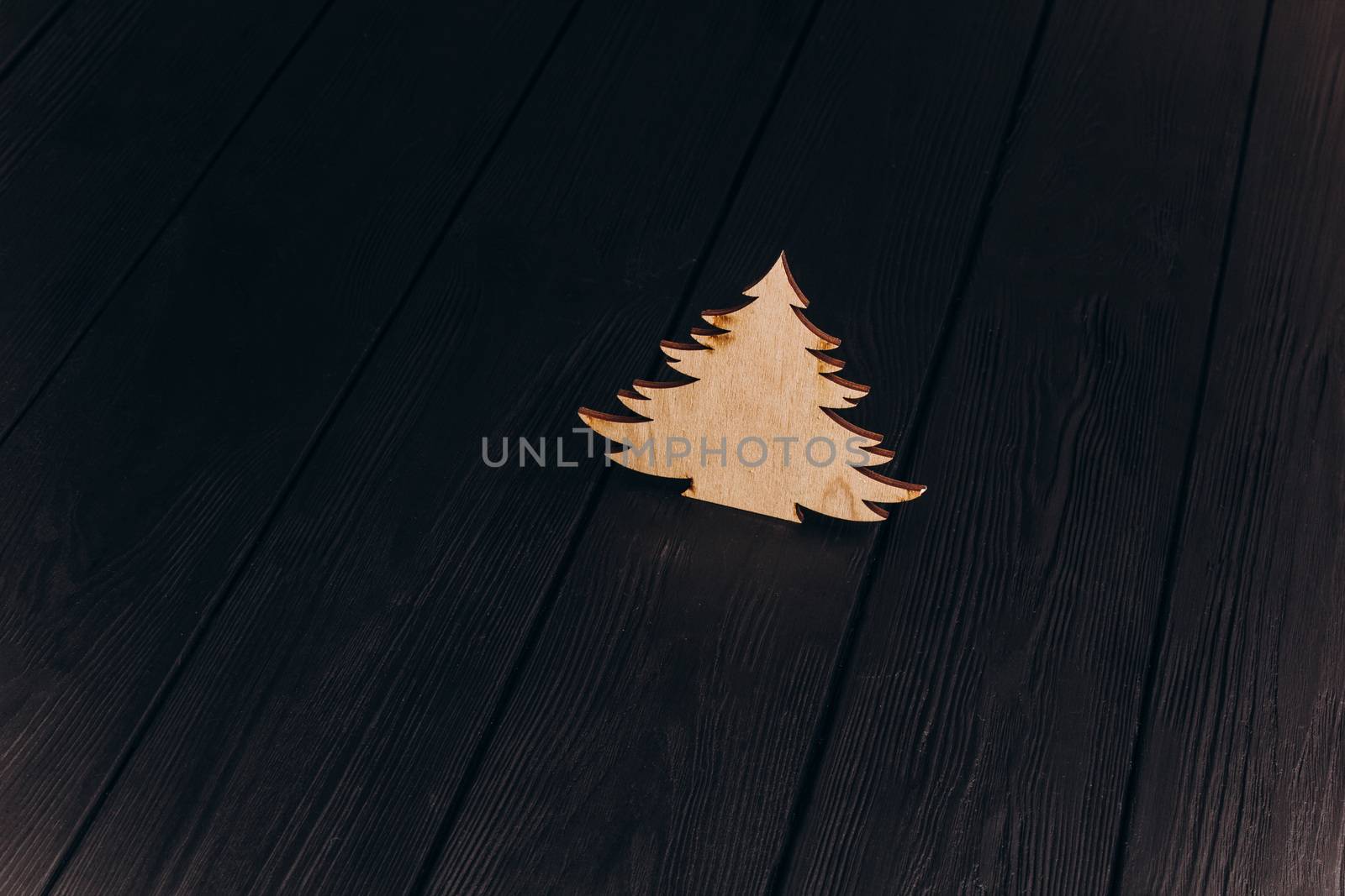 New Year composition with pine tree from plywood. Christmas background for presentation on wooden background by yulaphotographer