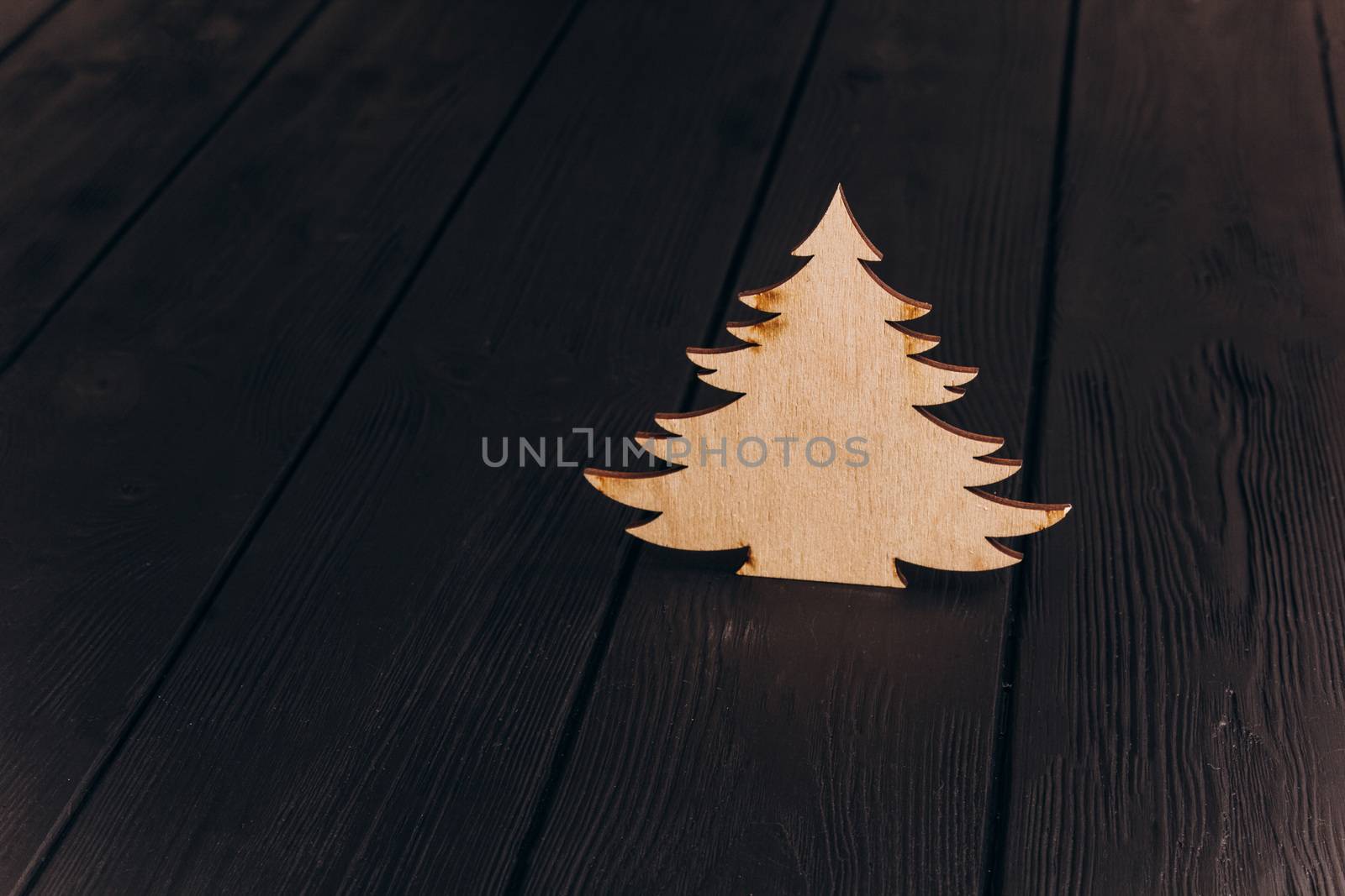 New Year composition with pine tree from plywood. Christmas background for presentation on wooden background by yulaphotographer