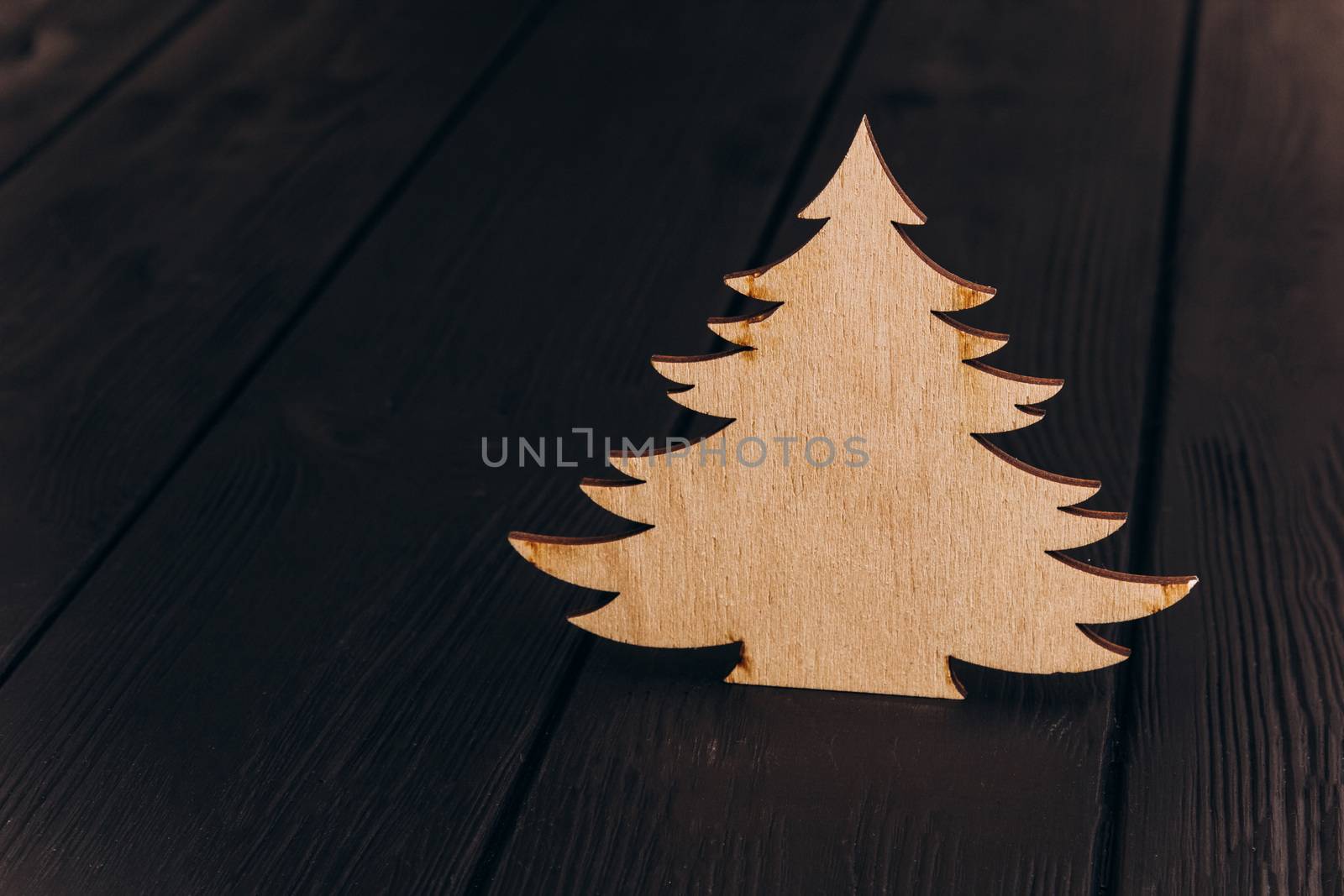 New Year composition with pine tree from plywood. Christmas background for presentation on wooden background by yulaphotographer
