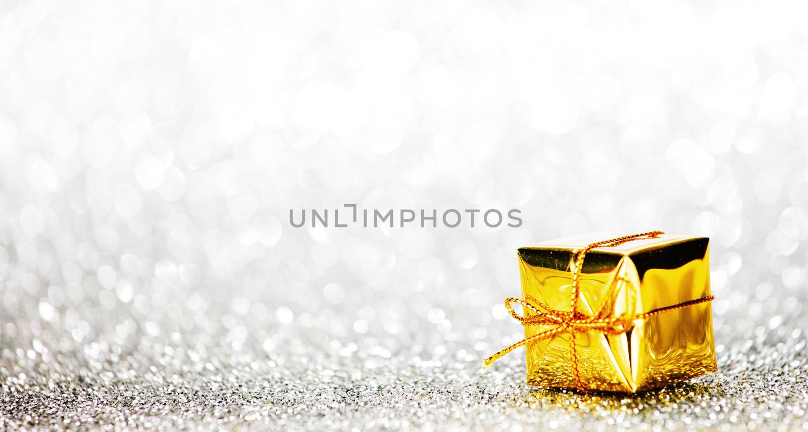 Decorative holiday gift box on bright shiny background