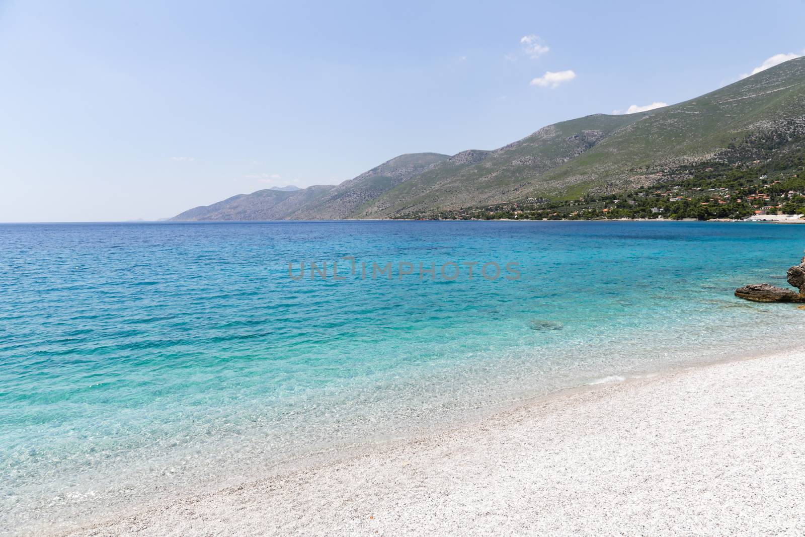 Clear turquoise water rocky beach of Porto Germeno, Attica, Greece