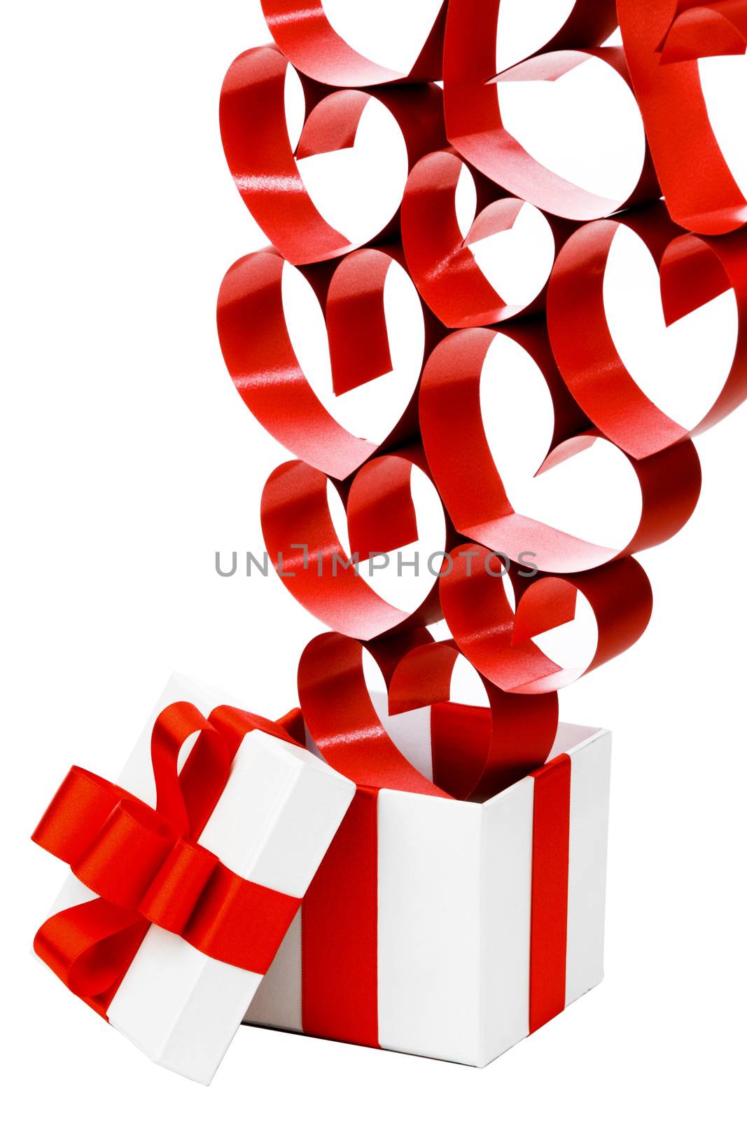Gift in white box with red ribbons and hearts isolated on white background