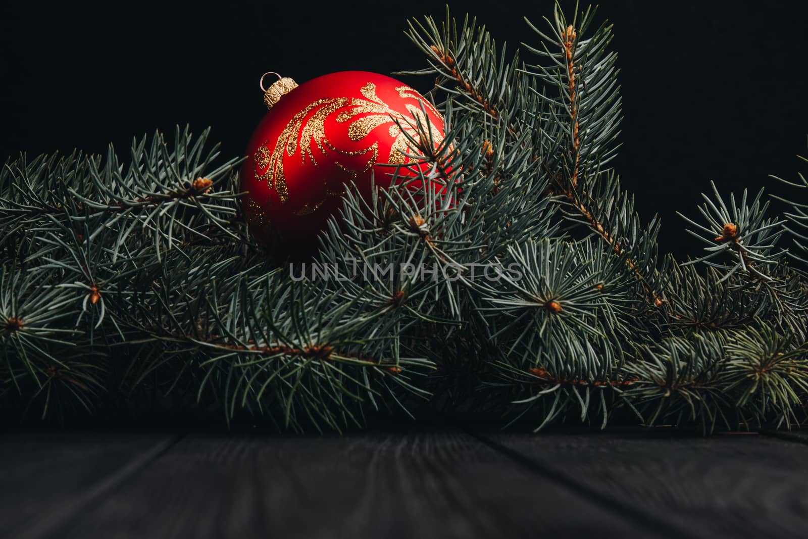 Christmas fir tree branches on wooden table. New year Christmas background with copy space. Greeting card.