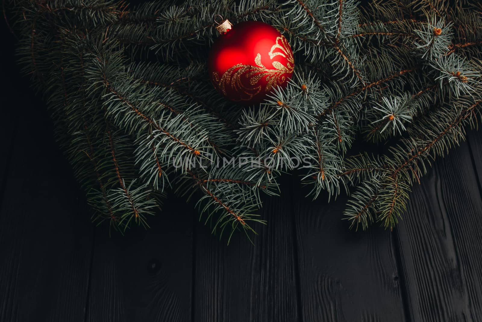 Christmas fir tree branches on wooden table. New year and Christmas background with copy space. Greeting card. by yulaphotographer