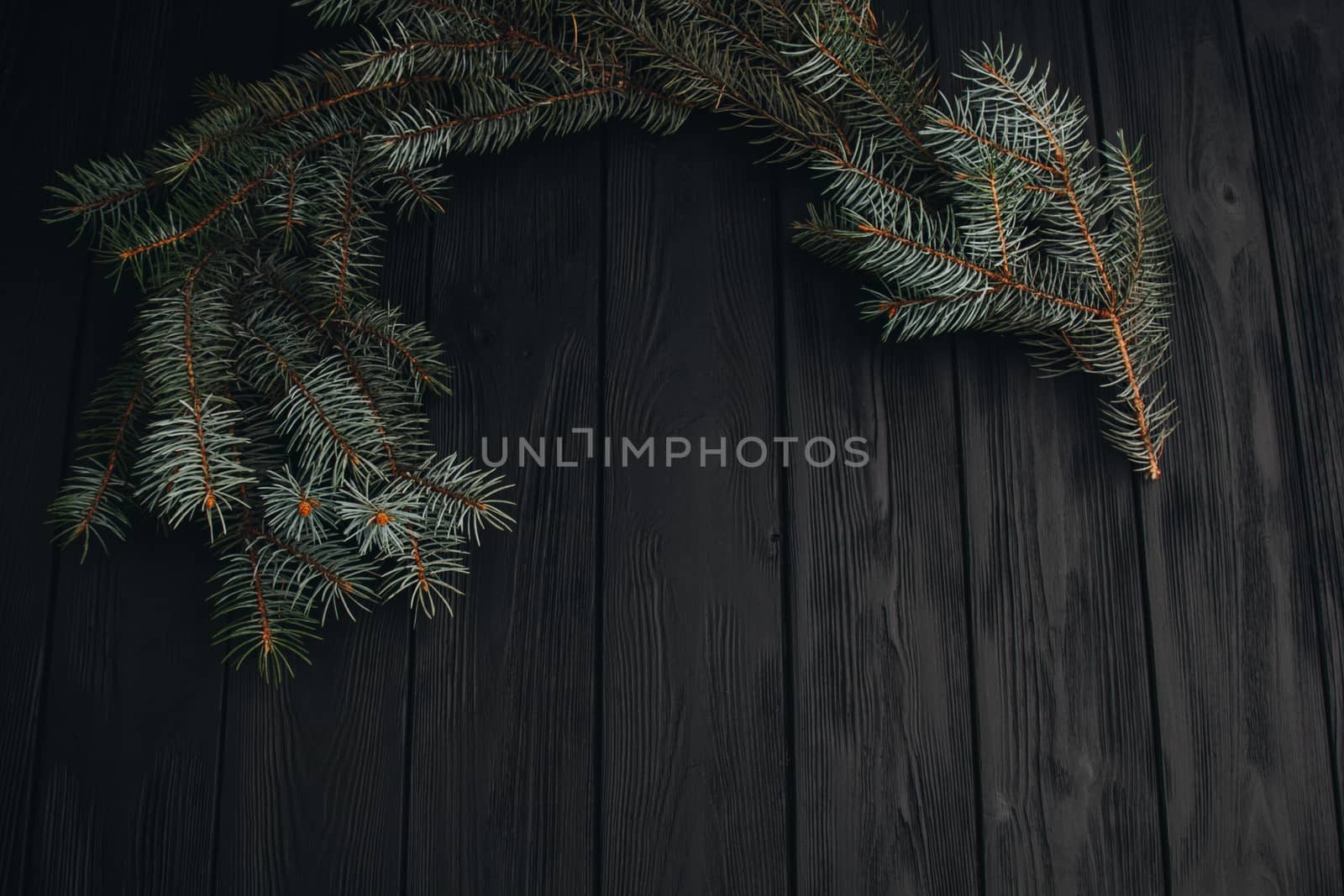 Christmas or New Year toy decorations golden ball and fur tree branch rustic on wooden background, top view, copy space