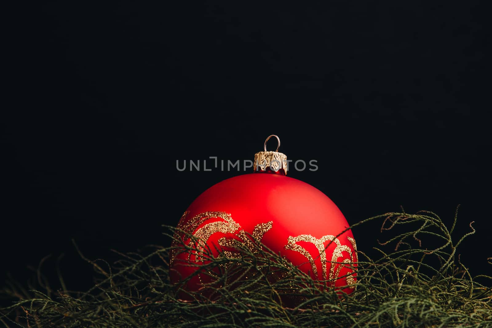 Christmas New Year decoration composition. Top view of fur-tree branches and balls frame on wooden background with place for your text.