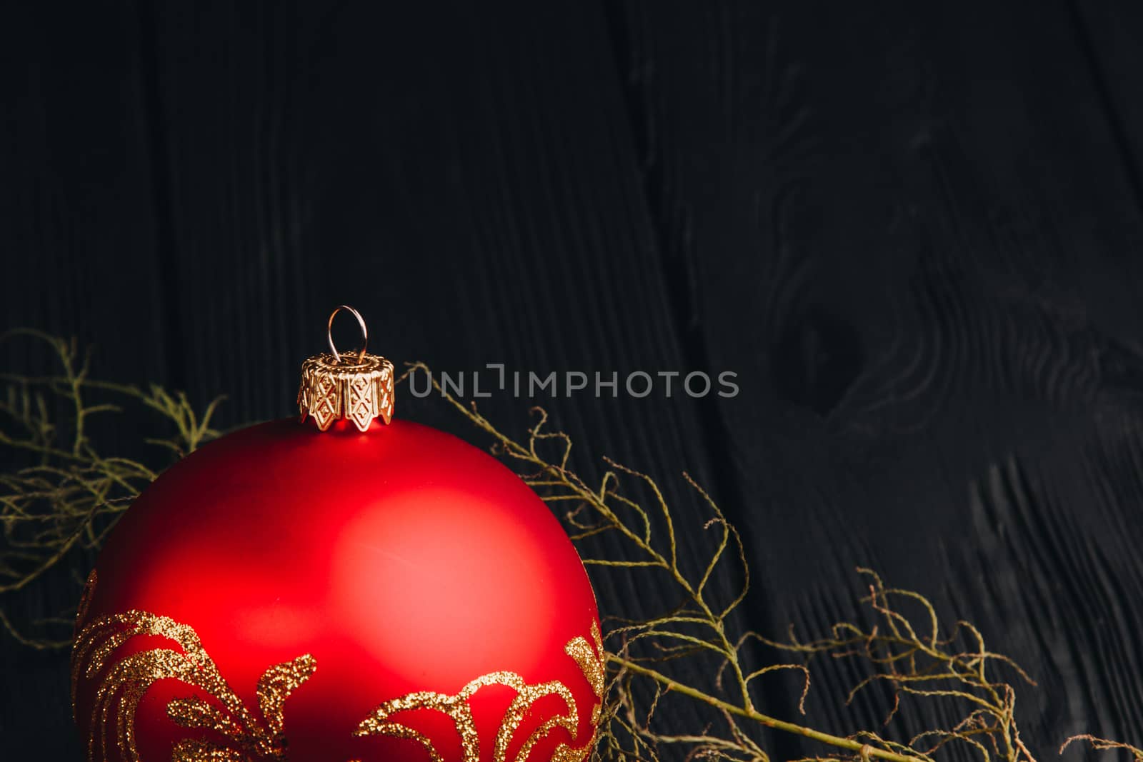 Christmas New Year decoration composition. Top view of fur-tree branches and balls frame on wooden background with place for your text. close up by yulaphotographer