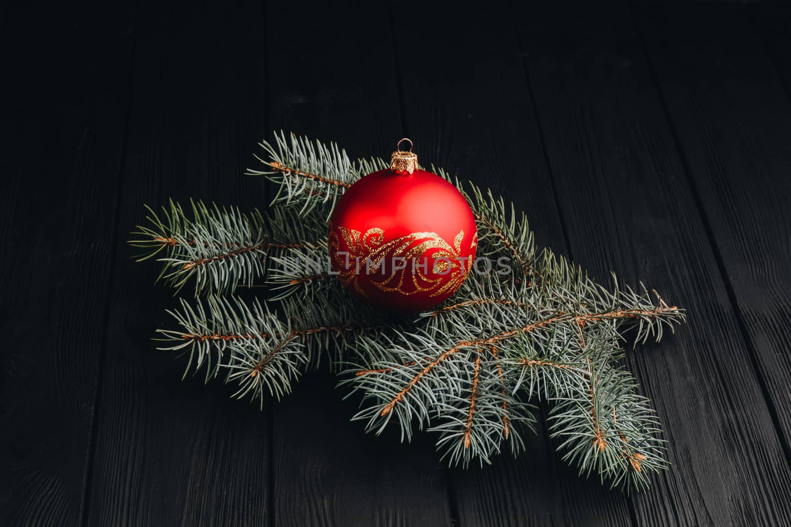 Christmas New Year decoration composition. Top view of fur-tree branches and balls frame on wooden background with place for your text.