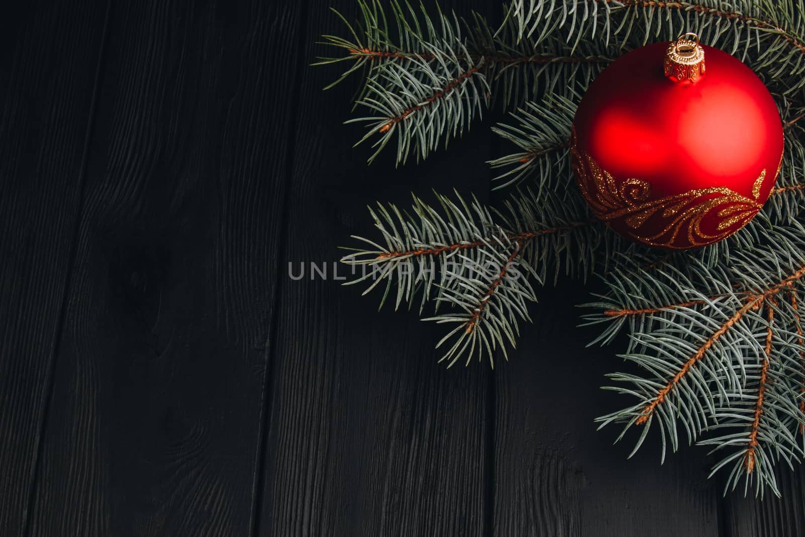 Christmas New Year decoration composition. Top view of fur-tree branches and balls frame on wooden background with place for your text. close up by yulaphotographer