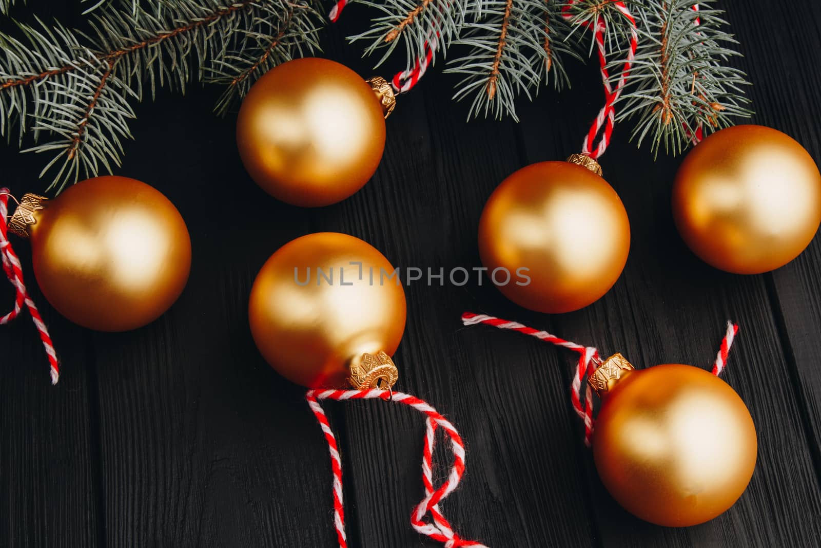 Colored christmas decorations on black wooden table. Xmas balls on wooden background. Top view, copy space. new year by yulaphotographer