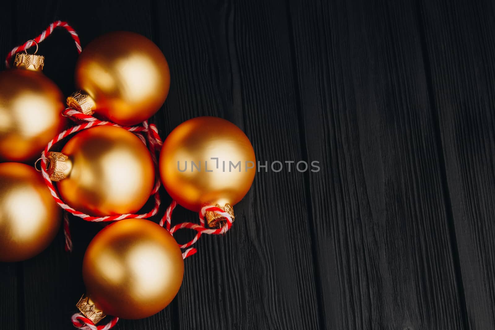 Colored christmas decorations on black wooden table. Xmas balls on wooden background. Top view, copy space. new year by yulaphotographer