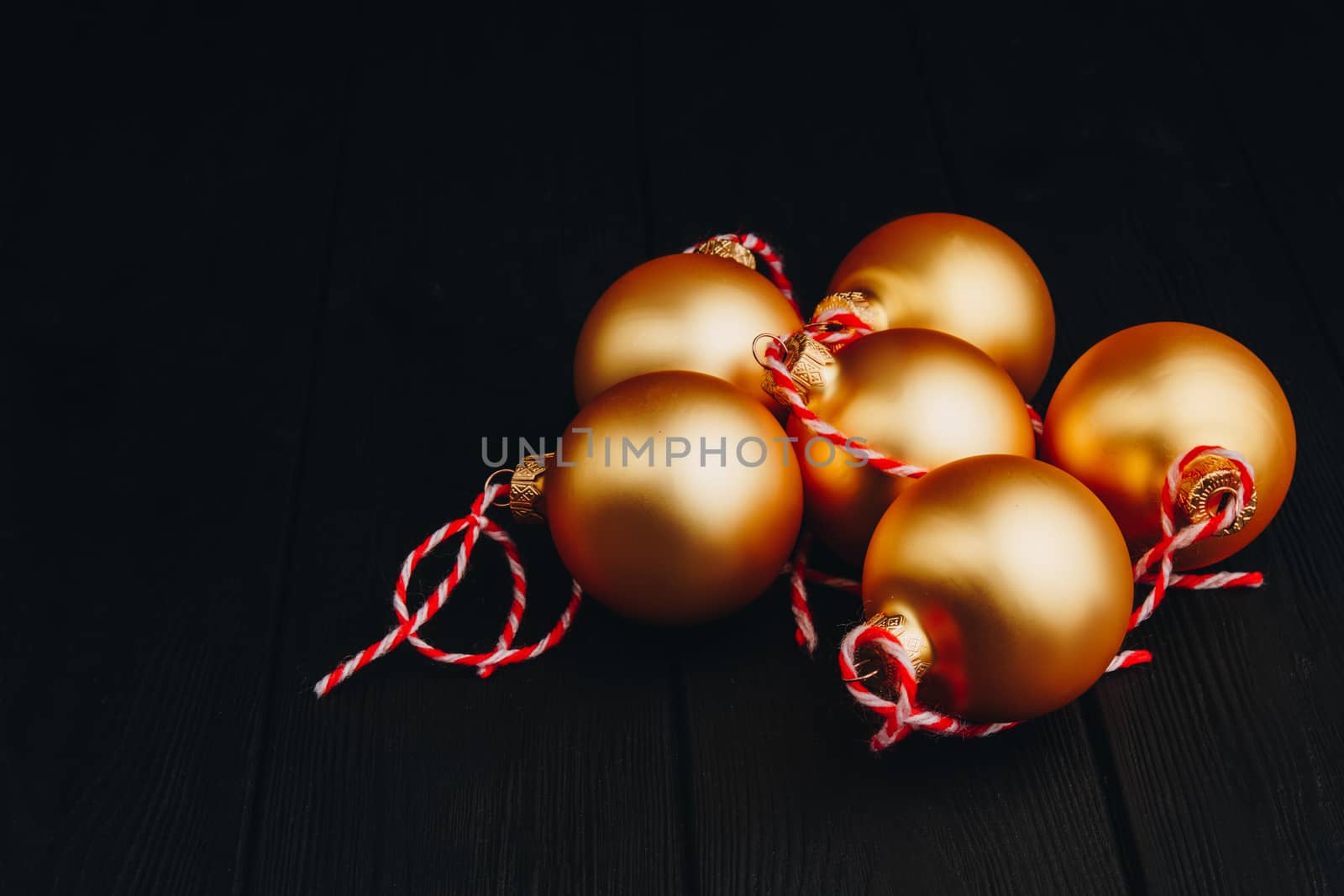 Colored christmas decorations on black wooden table. Xmas balls on wooden background. Top view, copy space. new year by yulaphotographer