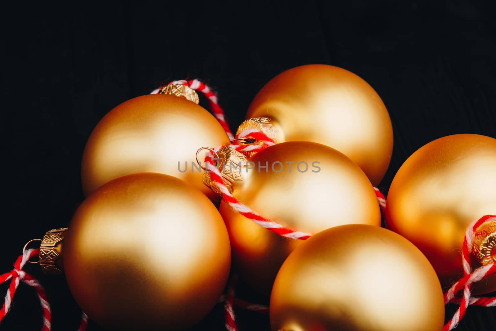 Colored christmas decorations on black wooden table. Xmas balls on wooden background. Top view, copy space. new year by yulaphotographer